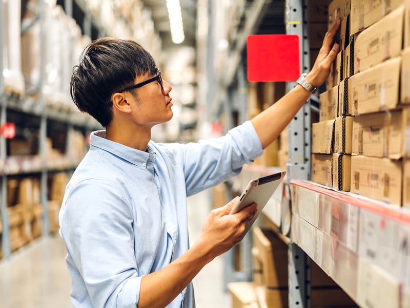 Man in warehouse on an ipad