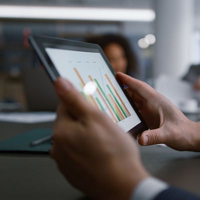 Man holding a tablet with finance reports