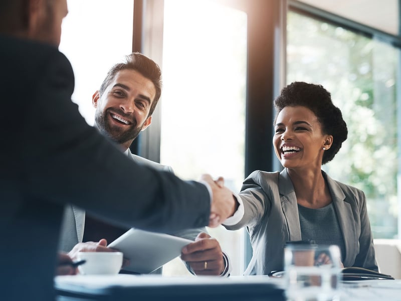 Woman and man shaking hands