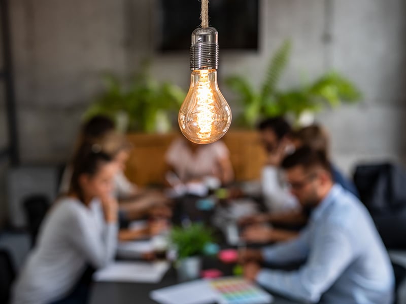 Light bulb over a group of people planning